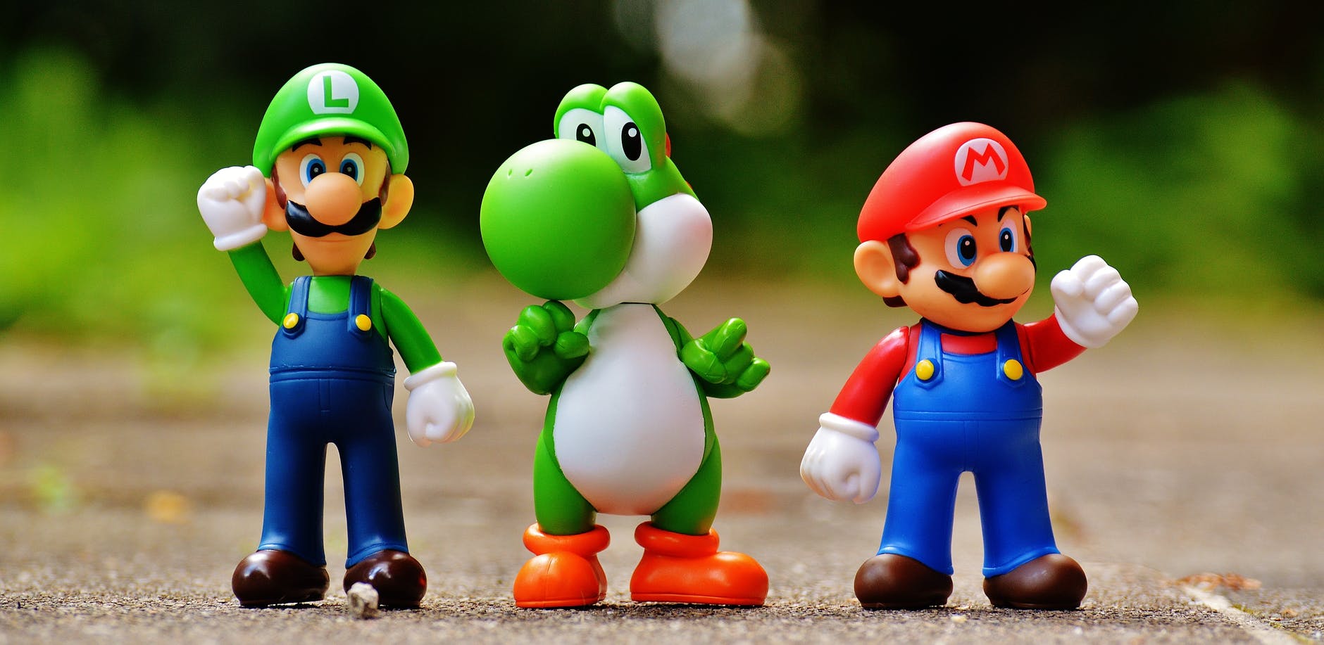 focus photo of super mario luigi and yoshi figurines